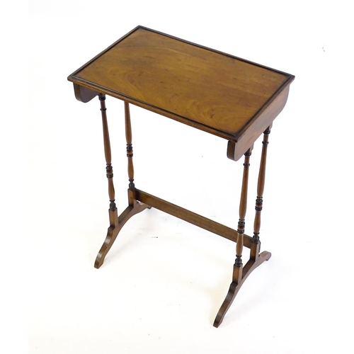 472 - A 19thC mahogany side table with turned tapering supports above shaped feet. 20