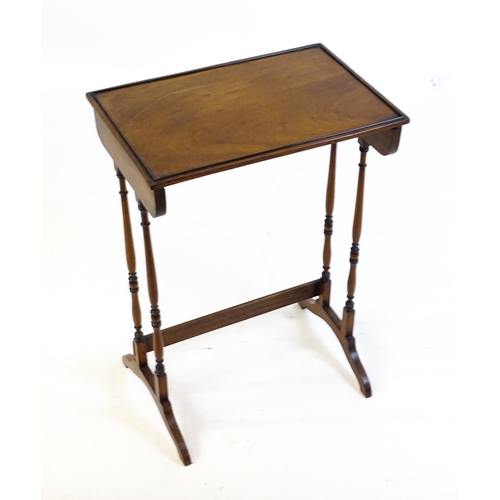 472 - A 19thC mahogany side table with turned tapering supports above shaped feet. 20