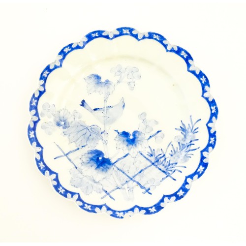 496 - A Japanese blue and white plate with scalloped edge, decorated with a bird perched on a branch with ... 