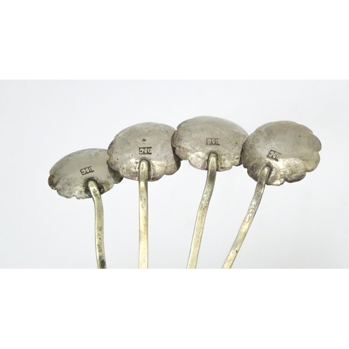 515 - A set of four Continental white metal salt spoons with floral detail to bowls and foliate handles. A... 