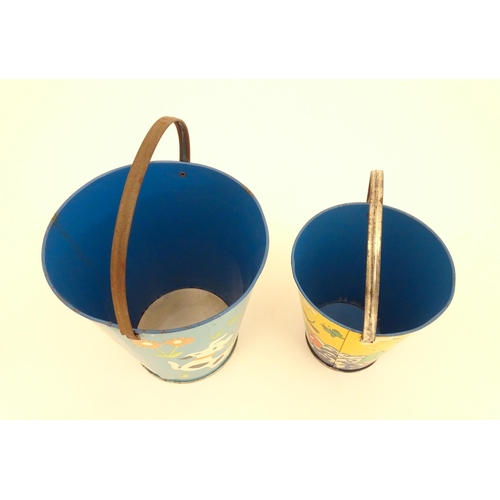 818 - Two vintage tin seaside buckets with swing handles, decorated with children playing. Largest approx.... 