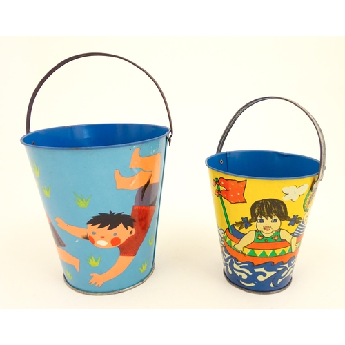 818 - Two vintage tin seaside buckets with swing handles, decorated with children playing. Largest approx.... 