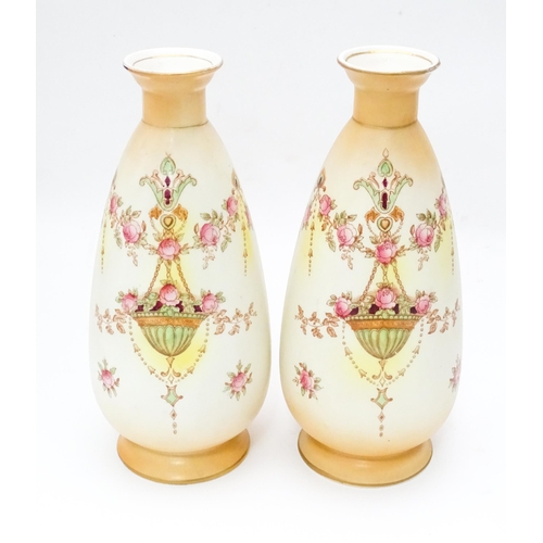 823 - A pair of Crown Devon vases in the Etna pattern. Marked under. Approx. 9 1/2