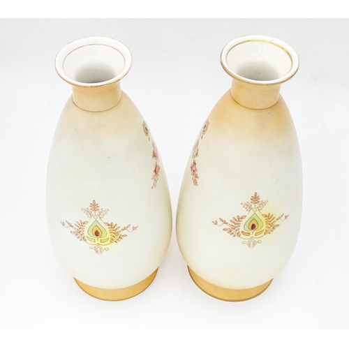 823 - A pair of Crown Devon vases in the Etna pattern. Marked under. Approx. 9 1/2