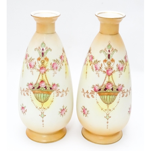 823 - A pair of Crown Devon vases in the Etna pattern. Marked under. Approx. 9 1/2