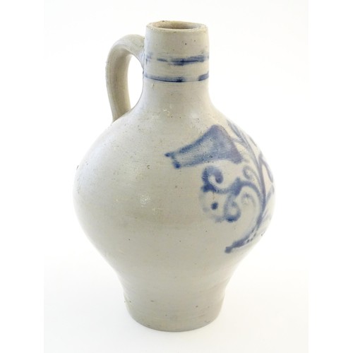 825 - A Continental stoneware vase / jug with bulbous body and single handle, decorated with stylised flor... 