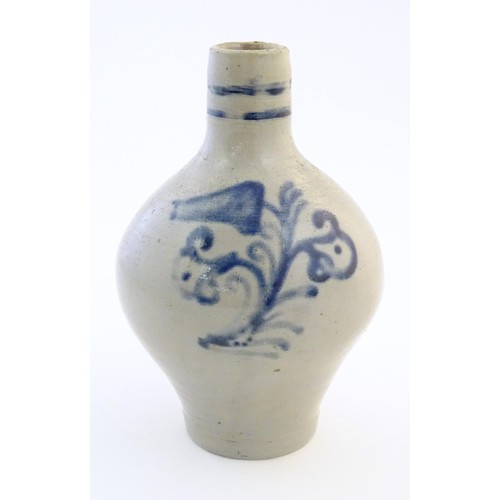 825 - A Continental stoneware vase / jug with bulbous body and single handle, decorated with stylised flor... 