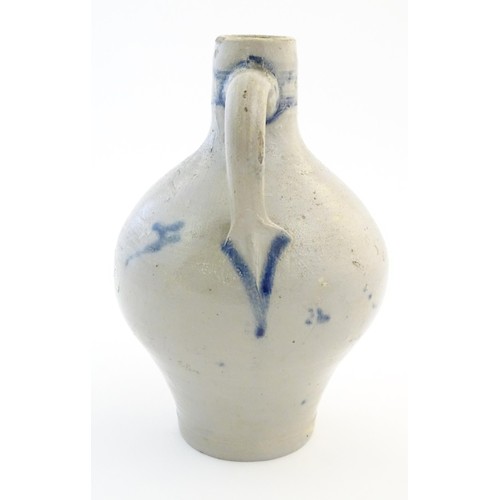 825 - A Continental stoneware vase / jug with bulbous body and single handle, decorated with stylised flor... 