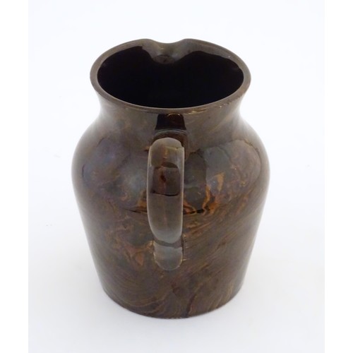 827 - An agate wear jug with loop handle. Approx. 4 1/2