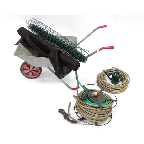 1078 - A quantity of gardening equipment including a wheelbarrow, hose etc.