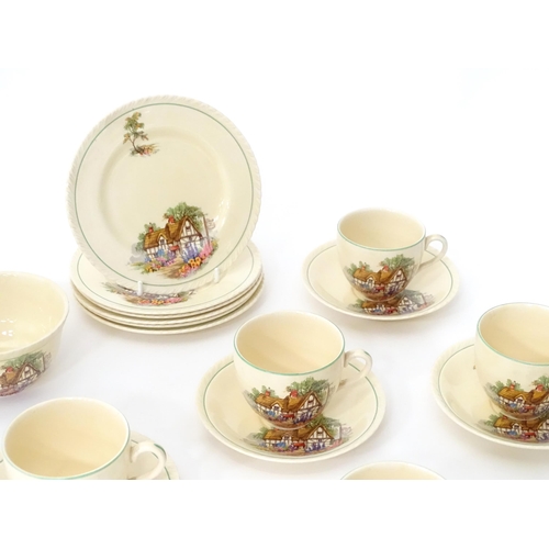 174 - A quantity of Crown Ducal tea wares decorated with a Hovis cottage and garden to include milk jug, s... 