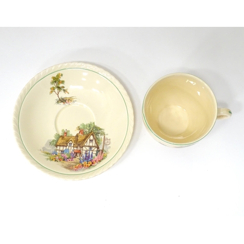 174 - A quantity of Crown Ducal tea wares decorated with a Hovis cottage and garden to include milk jug, s... 