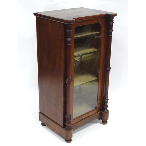 215 - A late 19thC / early 20thC music cabinet of larger proportions, having a castellated front edge, two... 