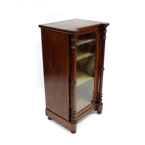 215 - A late 19thC / early 20thC music cabinet of larger proportions, having a castellated front edge, two... 