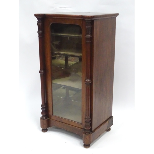 215 - A late 19thC / early 20thC music cabinet of larger proportions, having a castellated front edge, two... 