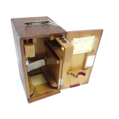 232 - Four assorted boxes / cases to include a writing slope, microscope case, etc. Largest approx. 18