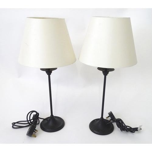 423 - A pair of modern cast metal table lamps in blacked finish, each approx 22