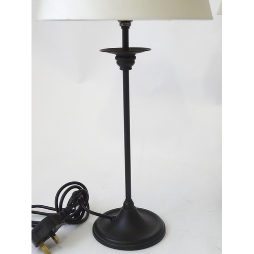 423 - A pair of modern cast metal table lamps in blacked finish, each approx 22