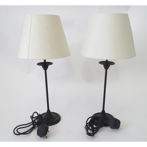 423 - A pair of modern cast metal table lamps in blacked finish, each approx 22