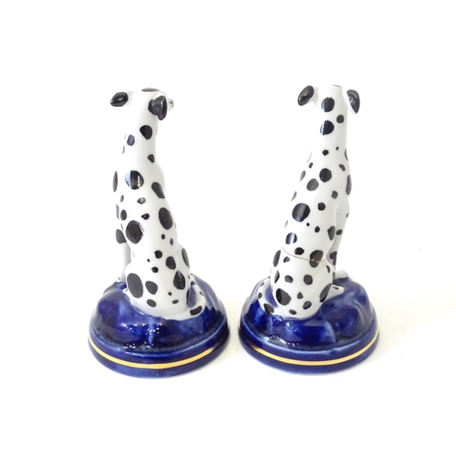 493 - A pair of Staffordshire style models of seated dalmatian dogs. Each approx 4