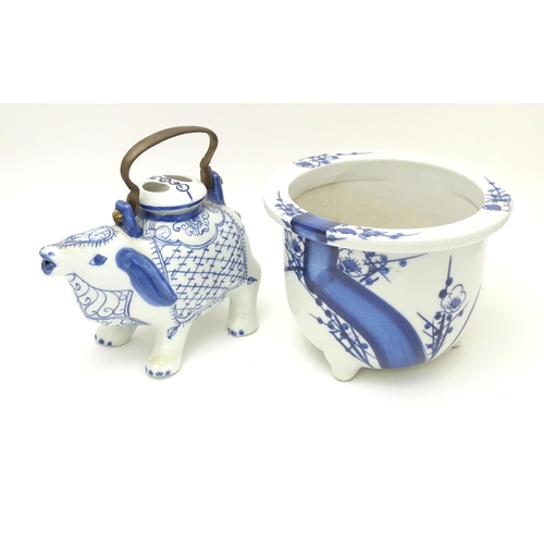 129 - A novelty blue and white teapot modelled as a mythical animal. Together with an Oriental blue and wh... 