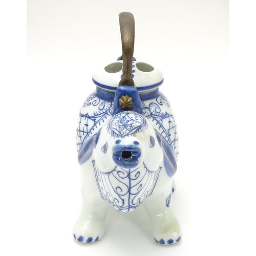 129 - A novelty blue and white teapot modelled as a mythical animal. Together with an Oriental blue and wh... 