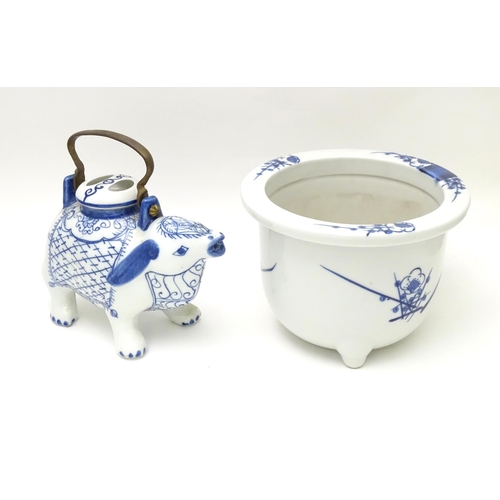 129 - A novelty blue and white teapot modelled as a mythical animal. Together with an Oriental blue and wh... 