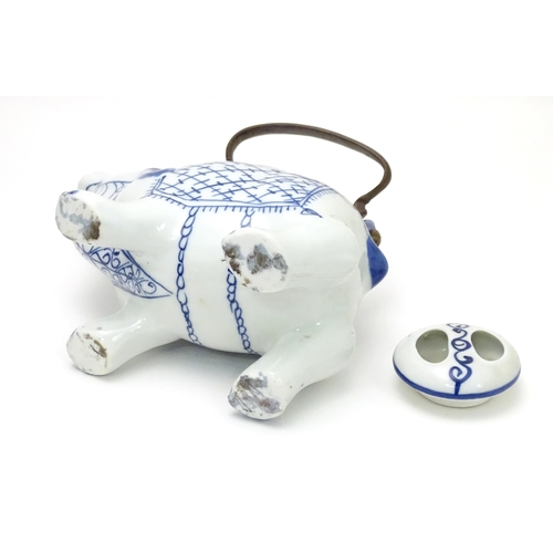 129 - A novelty blue and white teapot modelled as a mythical animal. Together with an Oriental blue and wh... 