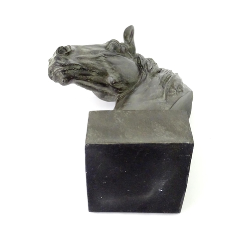 130 - A 20thC cast model of a horse head on a squared plinth. Together with a cast model of a standing hor... 