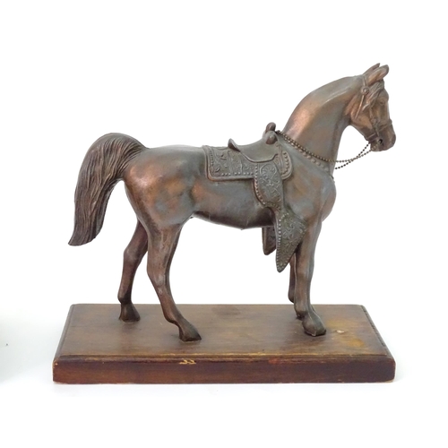 130 - A 20thC cast model of a horse head on a squared plinth. Together with a cast model of a standing hor... 