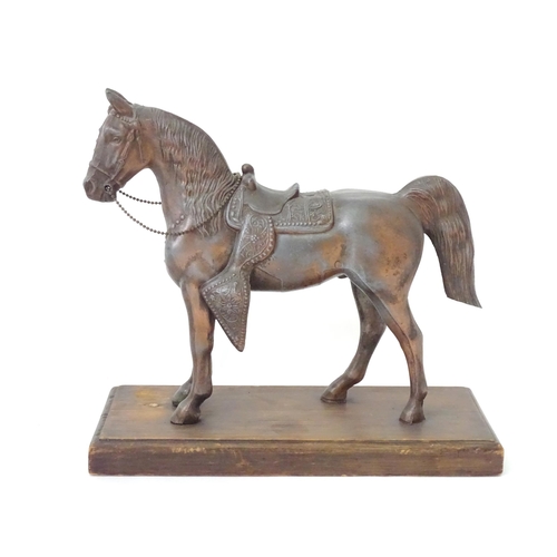 130 - A 20thC cast model of a horse head on a squared plinth. Together with a cast model of a standing hor... 