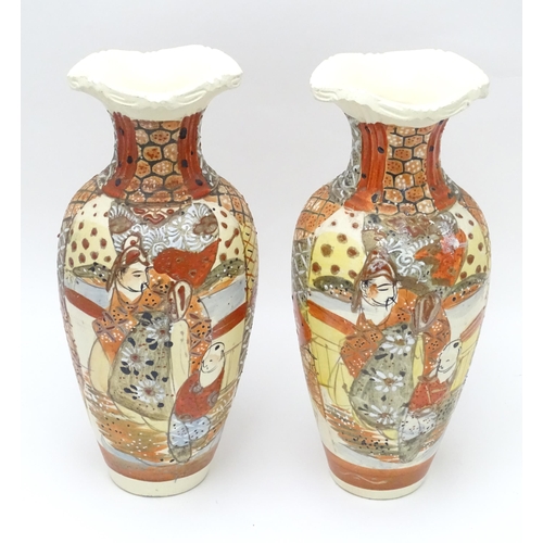 134 - A pair of Japanese vases decorated in the satsuma palette. Character marks under. Each approx. 10