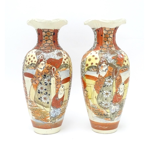 134 - A pair of Japanese vases decorated in the satsuma palette. Character marks under. Each approx. 10