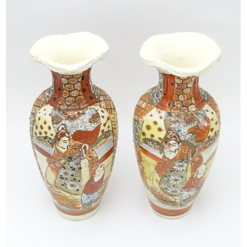 134 - A pair of Japanese vases decorated in the satsuma palette. Character marks under. Each approx. 10