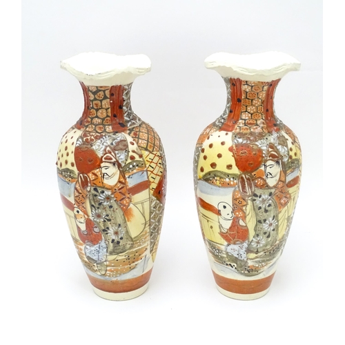 134 - A pair of Japanese vases decorated in the satsuma palette. Character marks under. Each approx. 10