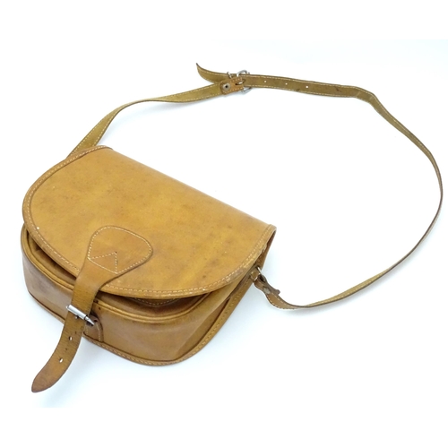 136 - Shooting : a late 20thC tan leather cartridge bag, with shoulder strap, choke compartment and pocket... 