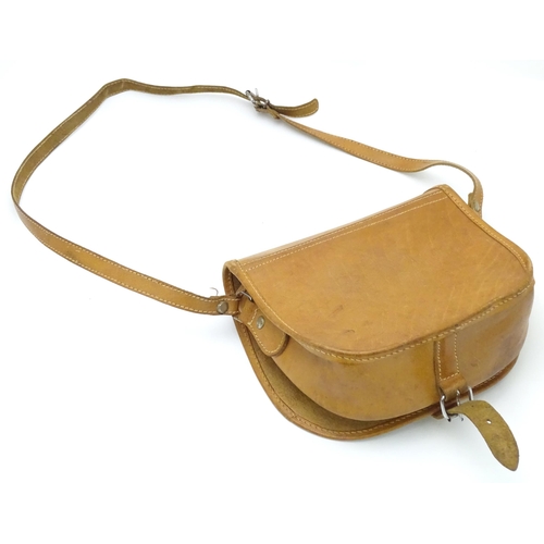 136 - Shooting : a late 20thC tan leather cartridge bag, with shoulder strap, choke compartment and pocket... 