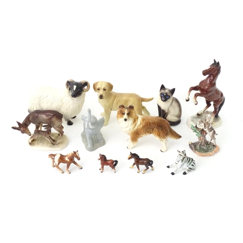 162 - A quantity of assorted ceramic models of animals to include cat, dog, deer, elephant, zebra, horses,... 