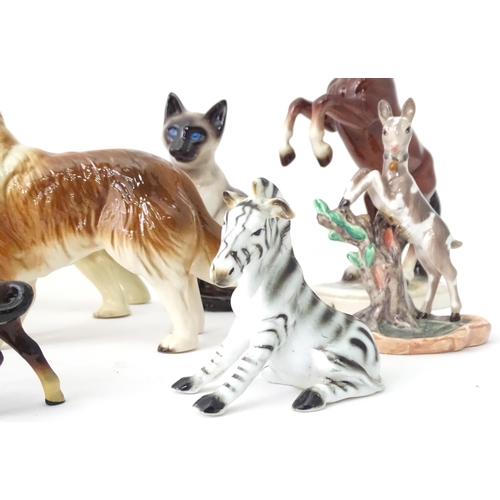 162 - A quantity of assorted ceramic models of animals to include cat, dog, deer, elephant, zebra, horses,... 