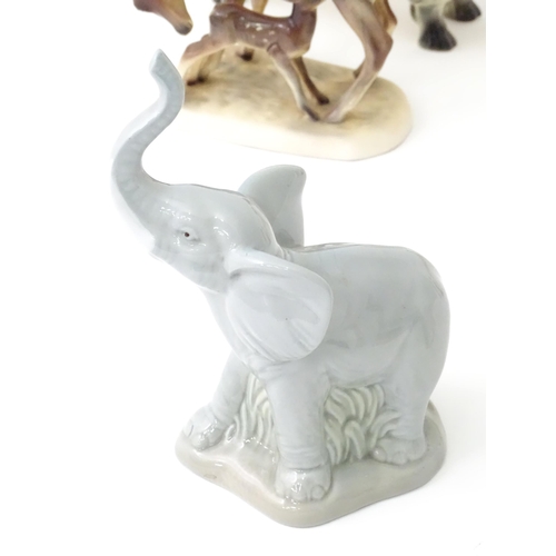 162 - A quantity of assorted ceramic models of animals to include cat, dog, deer, elephant, zebra, horses,... 