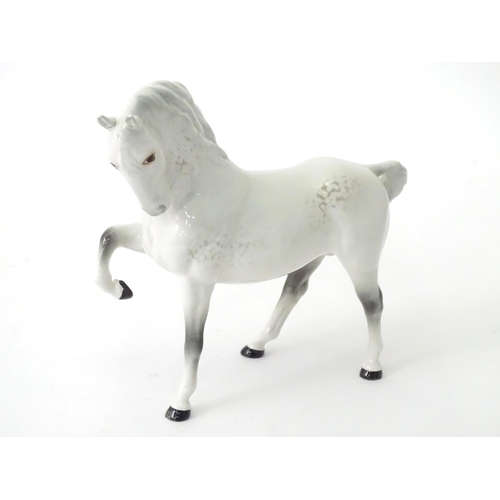 168 - A quantity of assorted Beswick models of horses to include dapple grey, palomino, etc. Together with... 