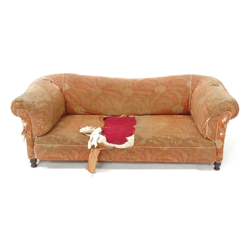 256 - A 19thC two seater Chesterfield sofa, with scrolled arms and standing on four carved feet, approx 75... 