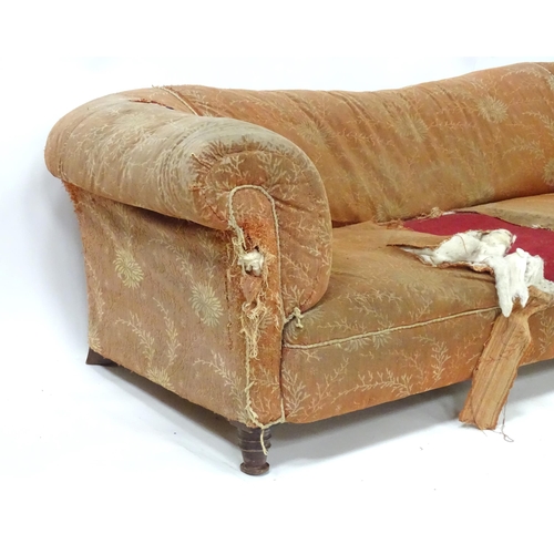 256 - A 19thC two seater Chesterfield sofa, with scrolled arms and standing on four carved feet, approx 75... 