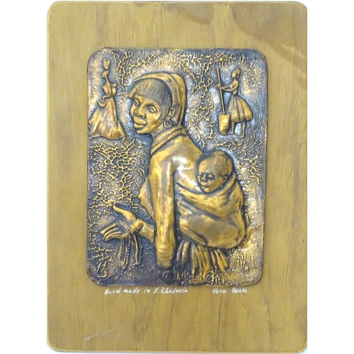 327 - A copper plaque depicting a mother and child. Signed under 'Handmade in S Rhodesia... Vera Maw'. App... 