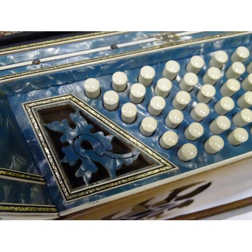 328 - Musical Instrument : a cased mid 20thC Frontalini accordion, with blue pearloid panels, 41 keys and ... 