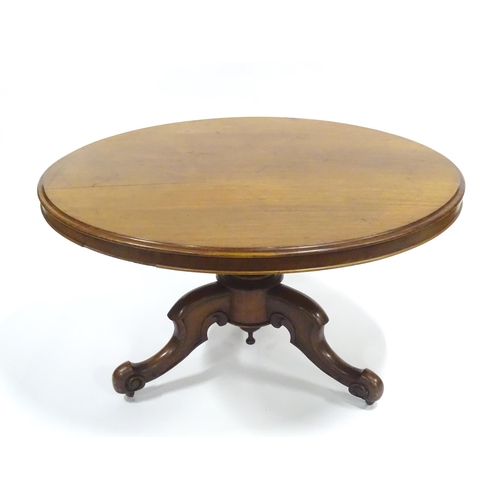 336 - A Victorian mahogany tilt-top breakfast table, the circular top supported by a turned baluster above... 