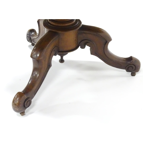 336 - A Victorian mahogany tilt-top breakfast table, the circular top supported by a turned baluster above... 