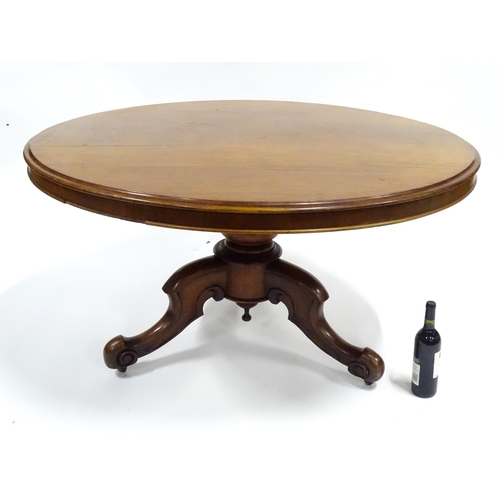 336 - A Victorian mahogany tilt-top breakfast table, the circular top supported by a turned baluster above... 