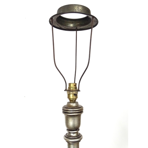 338 - A 20thC carved wooden standard lamp with a fluted and foliate column, circular stepped base and silv... 