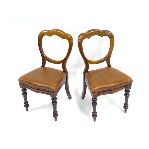 341 - A pair of 19thC mahogany balloon back chairs, the inset seats upholstered with brown leather. Each a... 